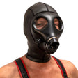 Person wearing a black gas mask with red straps on a white background